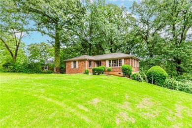 View of front facade with a front lawn and brick siding