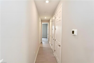 Corridor featuring baseboards, recessed lighting, 