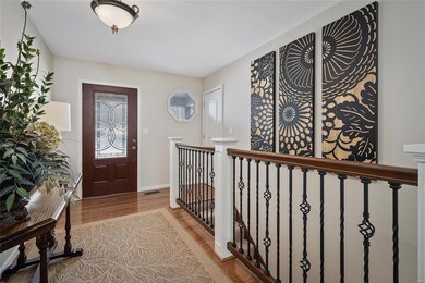 Beautiful foyer entry with hardwood flooring and n