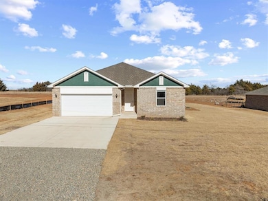 Single story home with concrete driveway, a garage