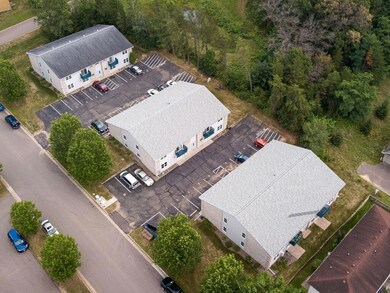Aerial view of three 8-plexes. Property has mature