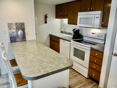 Kitchen featuring white appliances, sink, light LV
