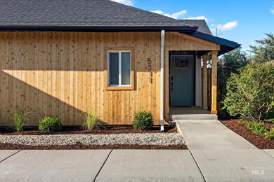 Entrance to property featuring a shingled roof