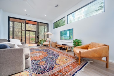 Living area featuring wood finished floors, reces