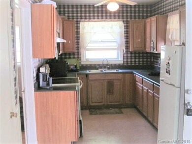 Kitchen with side door to screened in porch.