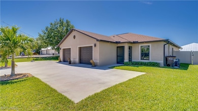 Ranch-style house with fence, an attached garage, concrete driveway, a front lawn, and stucco siding