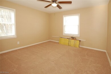 Bedroom with light colored carpet and ceiling fan