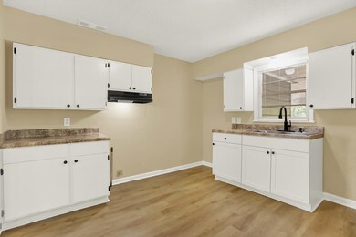 Kitchen featuring light wood-type flooring, sink, 