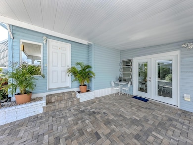 Double door entry to Florida room allows a golf cart to enter