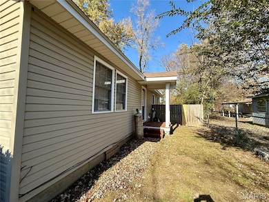View of side of property with a shingled roof