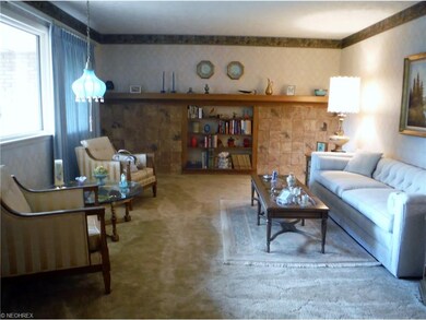 Large formal living room with unique stone tile wa