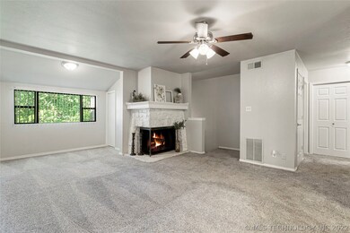 View of Living Room with Stone Encased Fireplace a