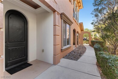 View of exterior entry featuring a gate and stucco