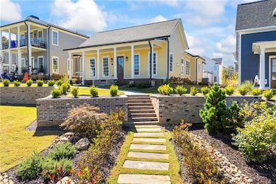 Rear view of property with a shingled roof, stairway, a porch, and a yard