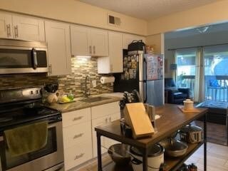 Renovated kitchen with shaker cabinets and stainle
