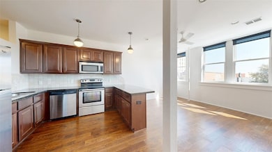 Kitchen with pendant lighting, visible vents, back
