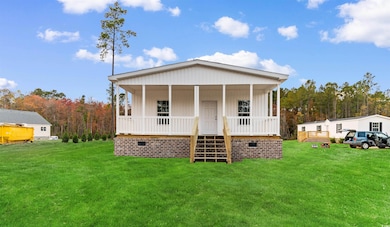View of front of property featuring a porch, a front lawn, and crawl space