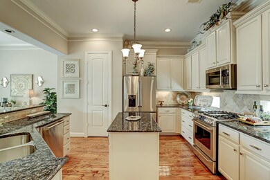 Kitchen features stainless GE Cafe appliances, gra