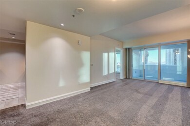 Carpeted Living room featuring baseboards and rece