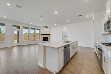 Kitchen featuring white cabinets, appliances with 