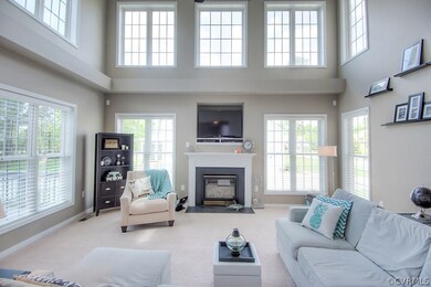 The two story family room boasts WALLS of WINDOWS