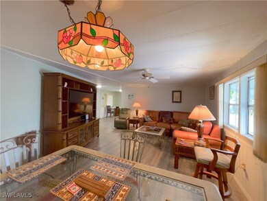 Living room featuring ceiling fan and hardwood / w