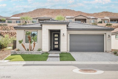Prairie-style home with an attached garage, a mountain view, decorative driveway, and stucco siding