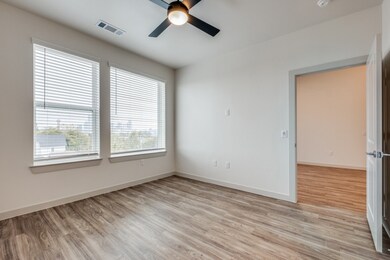 Unfurnished room with light wood-style floors and a ceiling fan