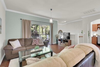 Living area with ornamental molding, dark wood fi