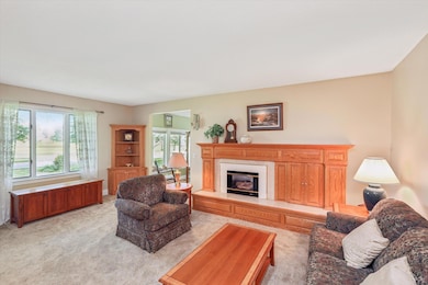 Living room with fireplace and view of the golf course