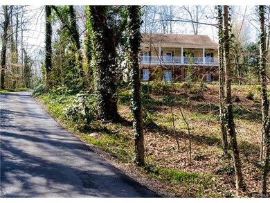 The paved driveway offers access from Riverside Dr