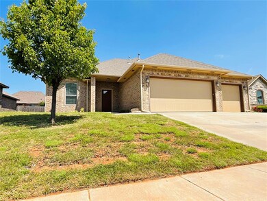 View of front facade with a garage and a front law