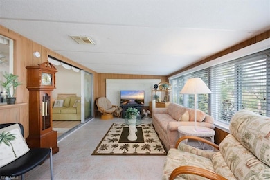 Tiled living room with wooden walls and a textured