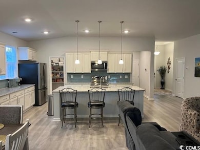 Kitchen with decorative backsplash, appliances wit