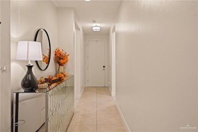 Hall with light tile patterned floors and baseboards
