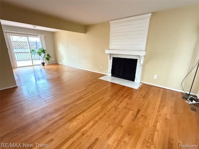 Unfurnished living room featuring a fireplace and wood finished floors