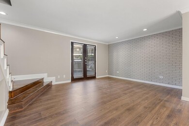 Unfurnished room with crown molding, brick wall, s