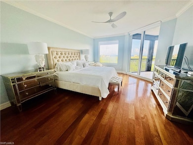 Bedroom with ornamental molding, wood finished floors, access to exterior, and ceiling fan