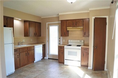 Kitchen featuring white appliances, under cabinet