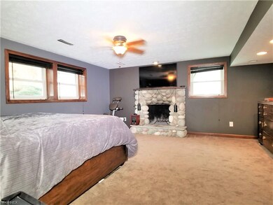 Master bedroom suite with beautiful stone gas or w