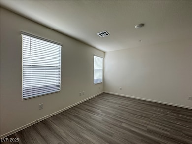 Spare room featuring dark wood-style flooring and