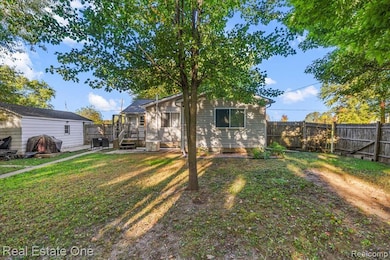 Fenced backyard featuring a deck