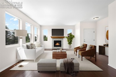 Virtually Staged. Living area featuring wood finished floors and a gas fireplace