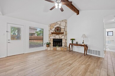 Living area featuring a ceiling fan, light wood-s