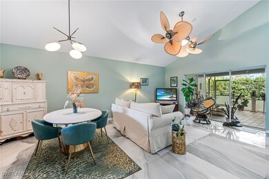 Living room featuring ceiling fan with notable cha