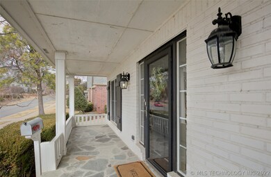The broad porch runs across the entire front
