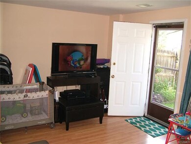 part of living room with doorway to fenced yard ou