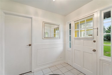 Entry showing front door and door into the hallway