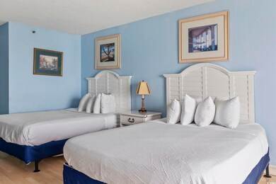 Bedroom with wood finished floors and a textured ceiling