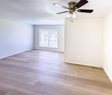 Unfurnished room with light wood finished floors and ceiling fan